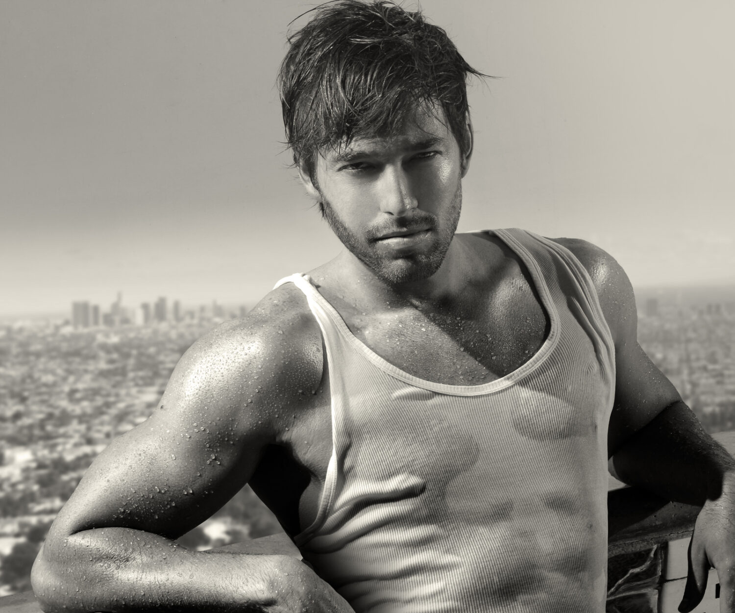 Classic black and white portrait of a young handsome man above city skyline
